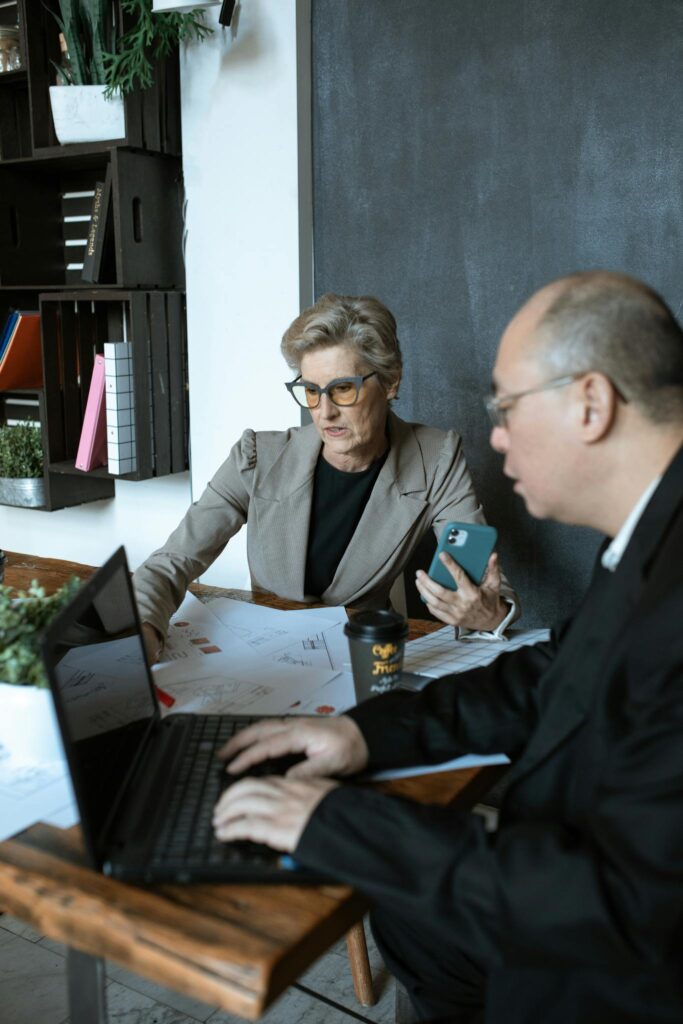 Photo by RDNE Stock project Man in Black Suit Jacket Sitting Beside Woman in Gray Long Sleeve Shirt
